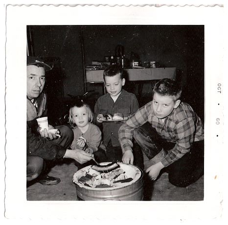 1961 - Barbecueing in the basement after a rainout (yikes!).jpg